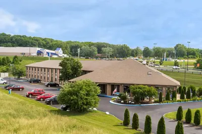 a large building with cars parked in a parking lot at Baymont by Wyndham Lancaster in Lancaster