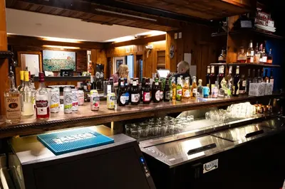 a bar with a lot of bottles of alcohol at Riverboat Inn & Suites in Madison