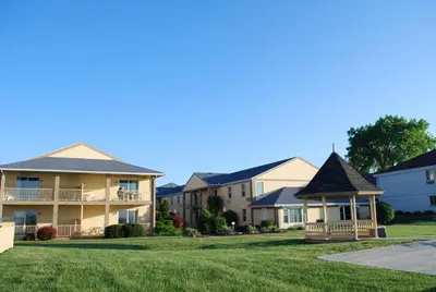 a row of apartment buildings with a gazebo at Clinton Inn & Suites in Port Clinton