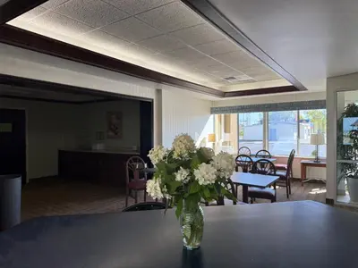 a vase of flowers sitting on a table in an office at Clinton Inn & Suites in Port Clinton