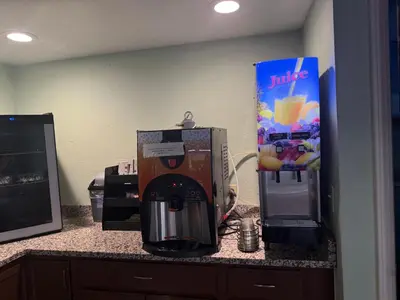 a coffee maker on a counter next to a juice box at Clinton Inn & Suites in Port Clinton