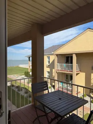 a patio with a table and chairs on a balcony at Clinton Inn & Suites in Port Clinton