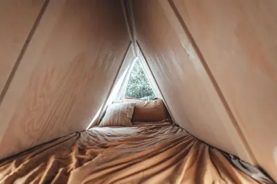 a bed in a tent with a window at Blue Brambler Glamping A-Frame in Rockbridge
