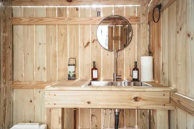 a bathroom with a sink and a mirror at Blue Brambler Glamping A-Frame in Rockbridge