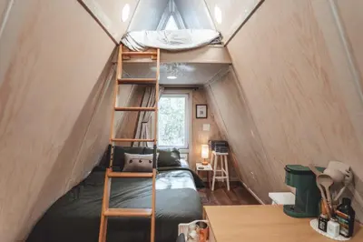 a bedroom with a bunk bed in a tiny house at The Green Glamping Getaway in Rockbridge