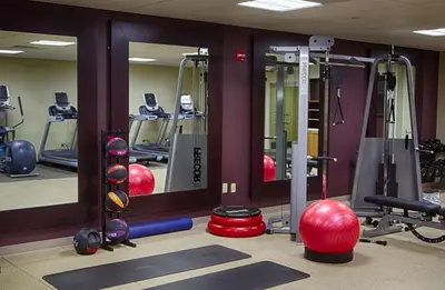 a fitness room with a gym with mirrors and equipment at DoubleTree by Hilton Lawrenceburg in Lawrenceburg
