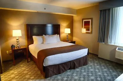 a hotel room with a large bed and two lamps at DoubleTree by Hilton Lawrenceburg in Lawrenceburg