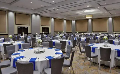 a ballroom with tables and chairs with blue and white linens at DoubleTree by Hilton Lawrenceburg in Lawrenceburg