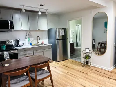 a kitchen with a table and a refrigerator at The Baker The Archive Lofts in Marion