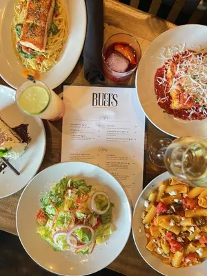 a table with plates of food and a menu at The Baker The Archive Lofts in Marion
