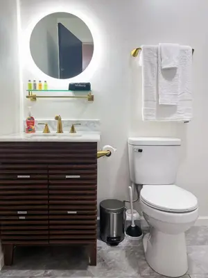 a bathroom with a toilet and a sink and a mirror at The True The Archive Lofts in Marion