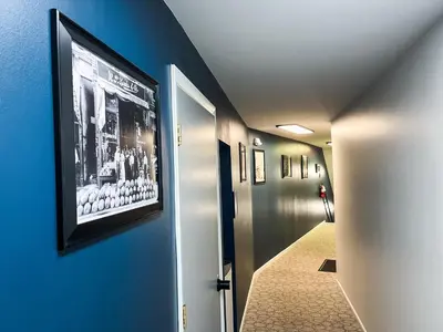 a hallway with a painting on a blue wall at The True The Archive Lofts in Marion