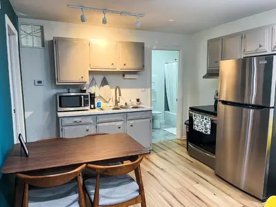 a kitchen with a table and a stainless steel refrigerator at The True The Archive Lofts in Marion