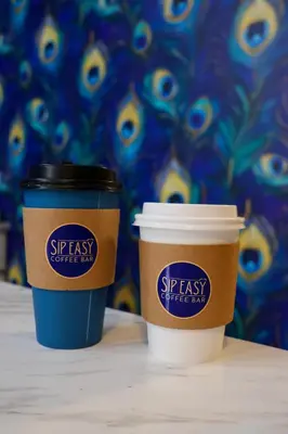 two coffee cups sitting next to each other on a table at The True The Archive Lofts in Marion