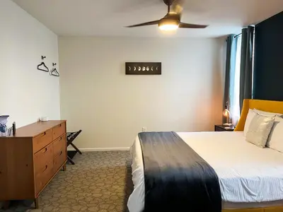 a bedroom with a bed and a ceiling fan at The True The Archive Lofts in Marion