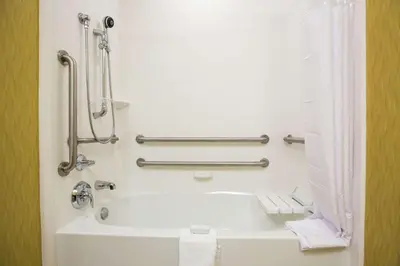 a bathroom with a bath tub in a hotel room at Hampton Inn & Suites Toledo/Westgate in Toledo