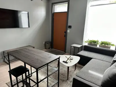 a living room with a table and a couch at Cozy Apartment in Historic OTR in Cincinnati