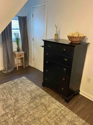 a dresser with a basket on top of it in a room at Lakeside Oasis/Golf Cart/Beach in Luna Pier
