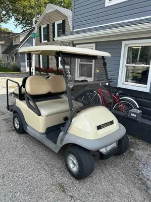 a golf cart parked in front of a house at Lakeside Oasis/Golf Cart/Beach in Luna Pier