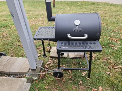 a grill sitting on a table in the grass at Grey Pines at Hocking Vacations in Logan