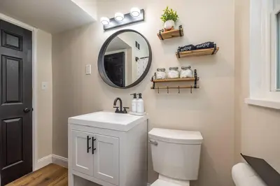 a bathroom with a toilet and a sink and a mirror at Close to airport* Pets*Fenced yard*A/C & Fast WIFI in Cleveland