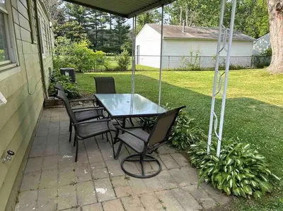 a table and chairs sitting on a patio at Close to airport* Pets*Fenced yard*A/C & Fast WIFI in Cleveland