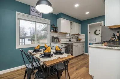 a kitchen with blue walls and a table with chairs at Close to airport* Pets*Fenced yard*A/C & Fast WIFI in Cleveland