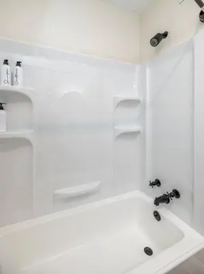 a white bathroom with a tub and a sink at Close to airport* Pets*Fenced yard*A/C & Fast WIFI in Cleveland
