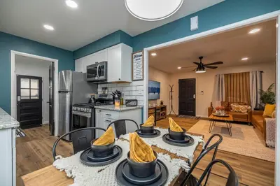 a kitchen and living room with a table and chairs at Close to airport* Pets*Fenced yard*A/C & Fast WIFI in Cleveland