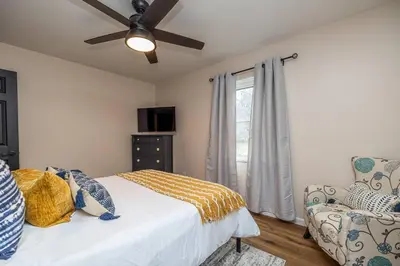 a bedroom with a bed and a ceiling fan at Close to airport* Pets*Fenced yard*A/C & Fast WIFI in Cleveland