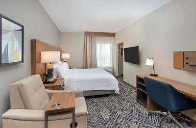 a hotel room with a bed and a desk at Candlewood Suites Erlanger - South Cincinnati by IHG in Erlanger