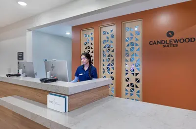 a woman sitting at a counter in a dental office at Candlewood Suites Erlanger - South Cincinnati by IHG in Erlanger