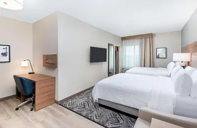 a hotel room with a bed and a desk at Candlewood Suites Erlanger - South Cincinnati by IHG in Erlanger