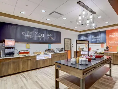 a fast food restaurant with a table in the middle at Hampton Inn & Suites Cincinnati Midtown Rookwood in Cincinnati