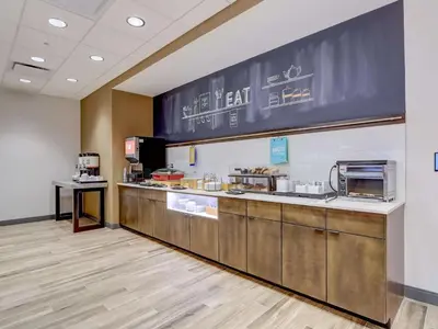 a restaurant kitchen with a counter with a chalkboard at Hampton Inn & Suites Cincinnati Midtown Rookwood in Cincinnati
