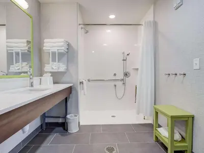 a white bathroom with a shower and a sink at Hampton Inn & Suites Cincinnati Midtown Rookwood in Cincinnati