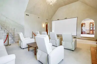 a room with white chairs and a white projection screen at Historic Auburn Home with Theater and Yard! in Auburn