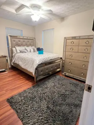 a bedroom with a bed and a dresser and a rug at Home sweet home in Columbus