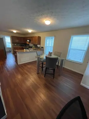 a living room with a table and a kitchen at Home sweet home in Columbus