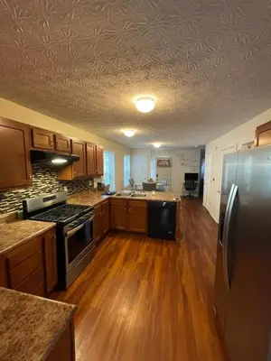 a kitchen with wooden floors and a stainless steel refrigerator at Home sweet home in Columbus