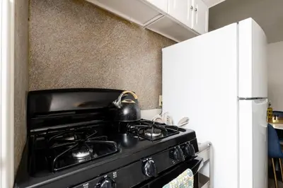 a black stove in a kitchen next to a refrigerator at Maple Heights Gem Libby Unit 1 in Maple Heights