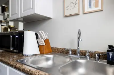 a kitchen counter with a sink and a microwave at Maple Heights Gem Libby Unit 1 in Maple Heights