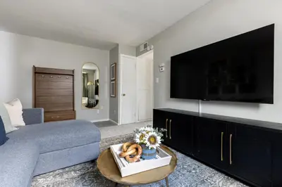 a living room with a couch and a flat screen tv at Maple Heights Gem Libby Unit 1 in Maple Heights