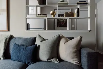a blue couch with pillows in a living room at Maple Heights Gem Libby Unit 1 in Maple Heights