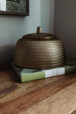 a wicker object sitting on top of two books at Maple Heights Gem Libby Unit 1 in Maple Heights