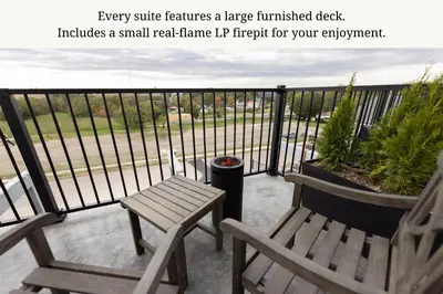 a balcony with two chairs and a bench at The Atlee Suites in Millersburg