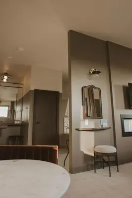 a room with a table and a mirror on the wall at The Atlee Suites in Millersburg