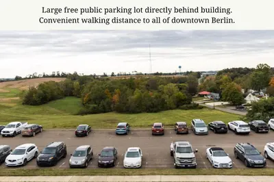 a parking lot with a bunch of cars parked at The Atlee Suites in Millersburg