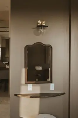 a mirror on a wall in a room at The Atlee Suites in Millersburg