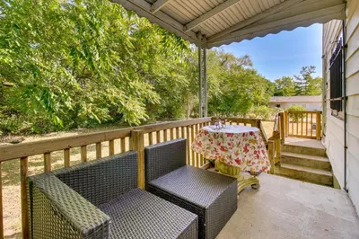 a patio with two chairs and a table on a porch at Cincinnati Home Rental with Balcony and Fire Pit! in Cincinnati
